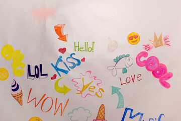 Colorful doodles and words like “Wow” and “Hello” on white background — playful and...