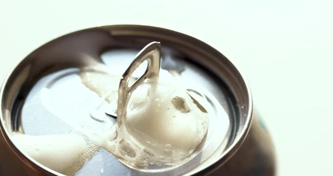 Close-Up of Beer Can Opening with Foamy Bubbles &ndash; Slow Motion Shot for Commercial Beverage Advertising and Refreshment Concepts. High-quality slow-motion video of a beer can being opened.