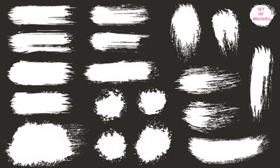 A set of brush strokes. A collection of vector white lines for grunge design and decor, isolated on a dark background.