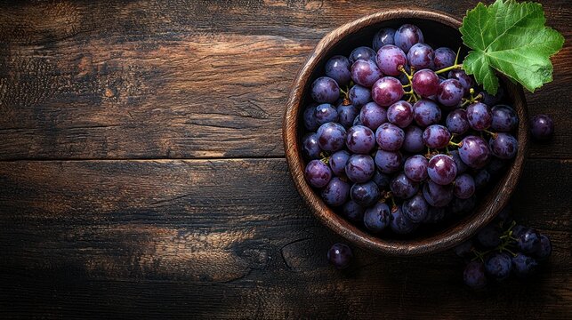 A Bowl of Fresh Ripe Red Grapes on Rustic Wooden Table