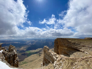 Picturesque view from the mountain bermamyt mountain peak with clouds and rocky outcrop captured on a sunny day in the highlands