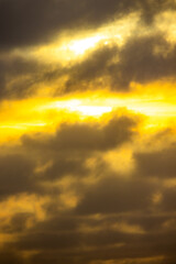 Fototapeta premium A stunning blend of yellow and gray clouds during sunrise, evoking feelings of calm and inspiration.