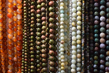 Strands of colorful natural agate beads at the gemstone market.