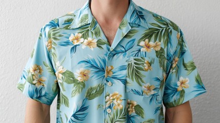 A man is wearing a blue Hawaiian shirt with yellow flowers