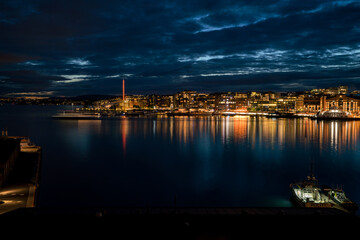 Dramatic evening  of Oslo waterfront with illuminated marina yachts
