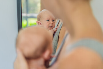 A mother lovingly embraces her newborn baby, holding them close to her chest. A tender moment of...
