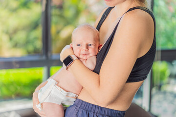 A mother lovingly embraces her newborn baby, holding them close to her chest. A tender moment of...
