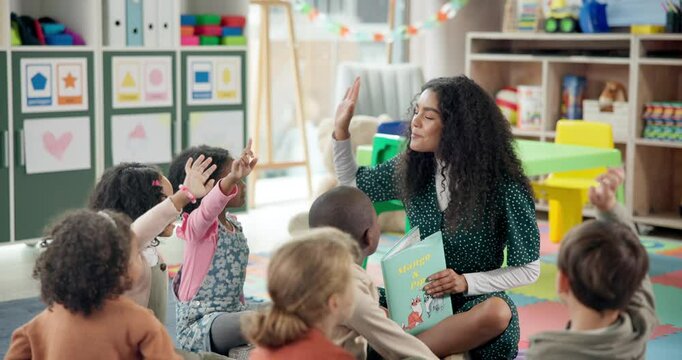 Woman, teacher and reading lesson with hands raised in nursery for question, engagement or interaction. Female person, educator or elementary kids with answer for story time or listening activity