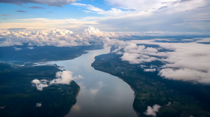 Naklejka premium Aerial view of a serene river winding through lush greenery and fluffy clouds under a vibrant sky.