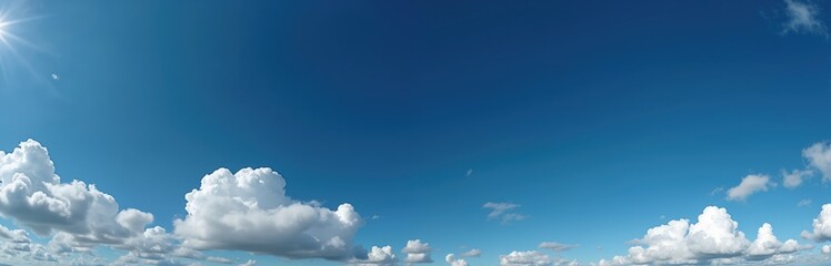 Panoramic photo of a bright blue sky with fluffy white clouds. Seamless panorama for 3D graphics or game development. Beautiful background perfect for sky replacement or drone shots.
