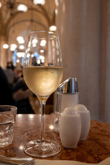 Lifestyle of beautiful Vienna, glass of cold white dry Austrian wine served in old Viennese-style cafe in Vienna, Austria
