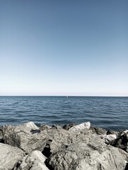 The rocks, the sea and the boat on a sunny day.