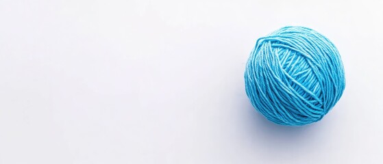 A single ball of light blue yarn on a white background.