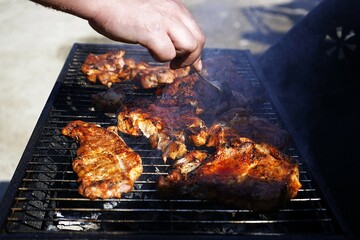 Juicy steaks sizzling on an outdoor grill. Smoky flavor, open fire, and perfect sear—authentic barbecue in nature. Great for food, camping, and outdoor cooking themes.