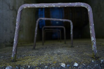 Old rusty ladder in a dark concrete shaft, leading into an unknown industrial space. Urban decay...