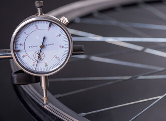 Checking a bicycle wheel with a dial gauge.