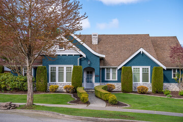 Two story stucco luxury house with nice spring blossom landscape in Vancouver, Canada, North...