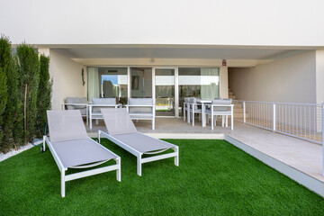 Terrace with loungers and sliding doors to living area