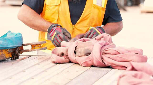 Crane operators hands loosening D-ring Bolt