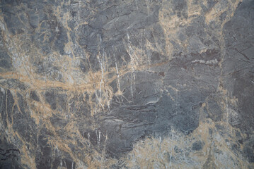 Dark marble texture with golden veins and natural patterns