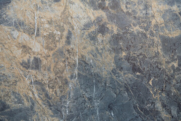 Luxurious stone texture with gold veins on a dark background