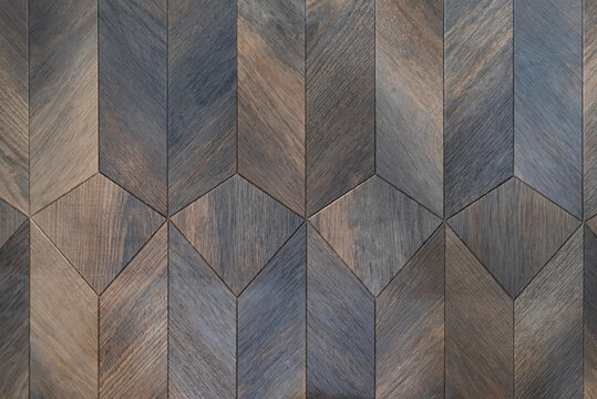 Wooden parquet with a geometric pattern in dark brown tones