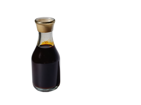 Small glass bottle of dark soy sauce with a golden cap against a white background.