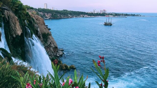 View of the Nizhny Duden waterfalls in Antalya, Turkey. Waterfalls fall from a rocky cliff into the Mediterranean Sea. The cascade is formed by the Duden River, one of the rivers in southern Anatolia.