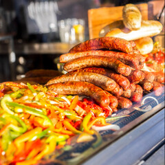 Fried sausages with onions and red peppers