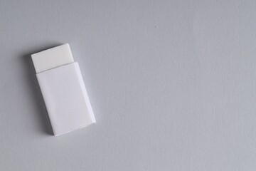 One eraser on grey background, top view. Space for text