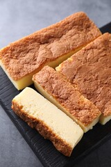 Tasty Japanese Castella sponge cake on grey table, closeup