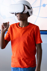 Using VR headset, boy in school exploring virtual reality experience