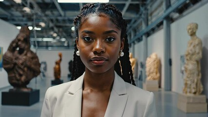 Portrait of woman with modern art sculptures on display at a museum gallery, showcasing aesthetic appreciation and cultural enrichment.