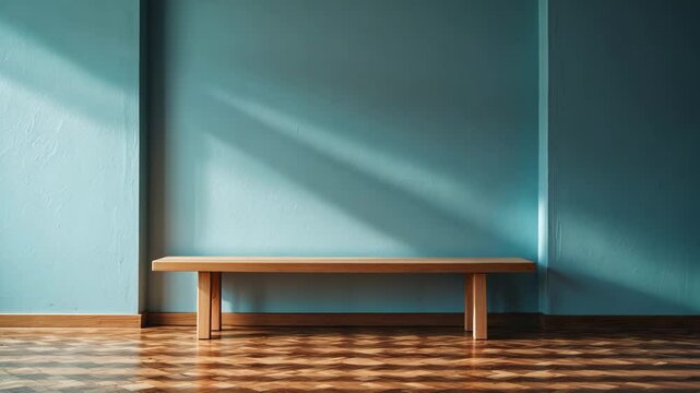 A wooden bench is placed on parquet flooring in an empty room with a wall.