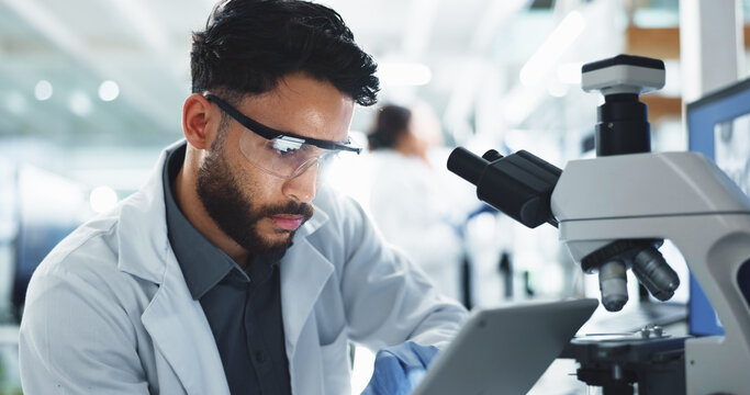 Tablet, man and scientist with microscope in laboratory for online research with DNA for medical innovation. Biotechnology, goggles and male biologist with RNA for pharmaceutical study or discovery.