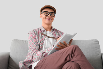 Male author with feather writing on paper at home