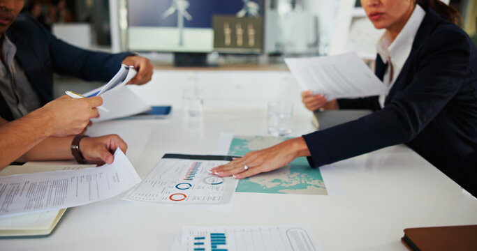 Business people, hands or team with paperwork for data, discussion or wind turbine metrics. Document, charts or planning in meeting for strategy, sustainability map or clean energy contract in office