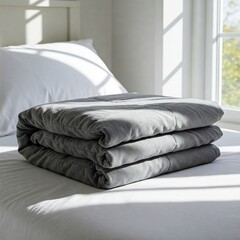 Minimal flat lay – folded weighted blanket on crisp white bedding with centered copyspace