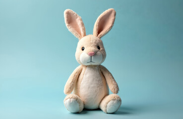 Obraz premium Soft toy rabbit on blue background. Cute Easter Bunny doll, with fur. Plush bunny, symbol of Easter. Concept of holidays, celebration, childhood. Adorable gift for kids.