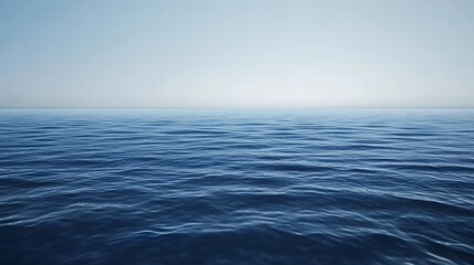 Fototapeta premium Calm ocean water surface with a clear sky above.