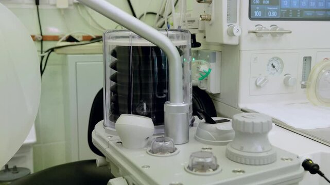 Close up of medical equipment bellows rhythmically expanding and contracting during a surgical procedure in an operating room
