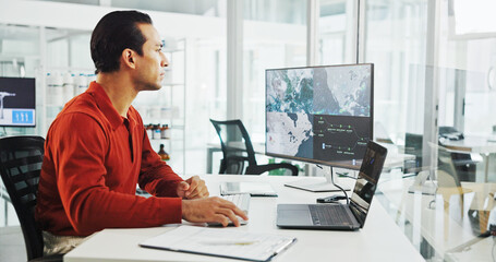 Computer screen, map and wind turbine with business man in office for renewable energy or sustainability. Electricity, laptop and windmill with location on display for development or engineering