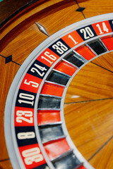 Obraz premium roulette wheel close-up showcasing vibrant colors and numbered pockets. ideal for gambling themes, casinos, or game nights. perfect for marketing casino experiences or gaming-related content