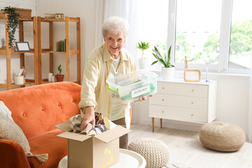 Senior woman sorting trash at home