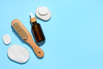 Obraz premium Composition with bottle of essential oil, spa stones and massage brush on color background