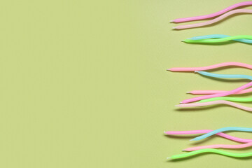 Many colorful Birthday candles on green background