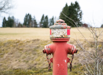 A red fire hydrant with a chain on it