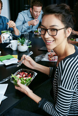 Discussion, happy and portrait of woman with salad in office for team building lunch for collaboration. Meeting, smile and business with female designer with colleagues eating healthy in workplace
