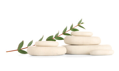 Spa stones with eucalyptus branch on white background