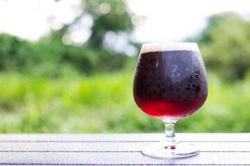 Glass  of craft beer on a green natural background